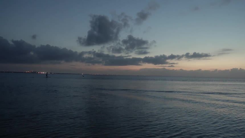 Water ripples on a beach at sunset