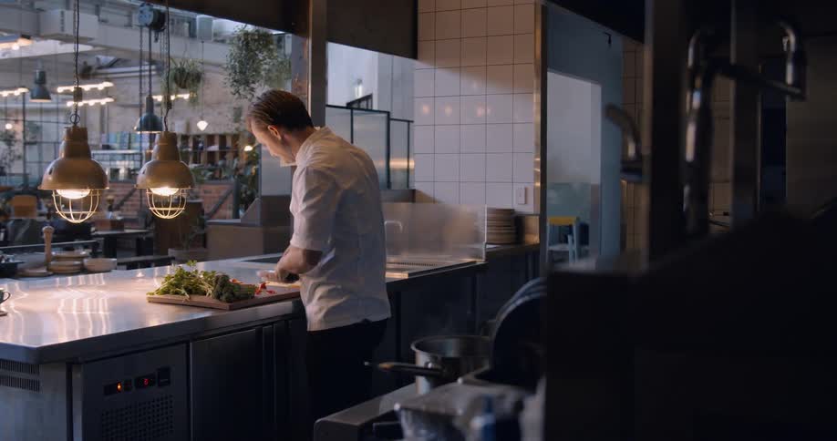 A man is preparing food in the kitchen