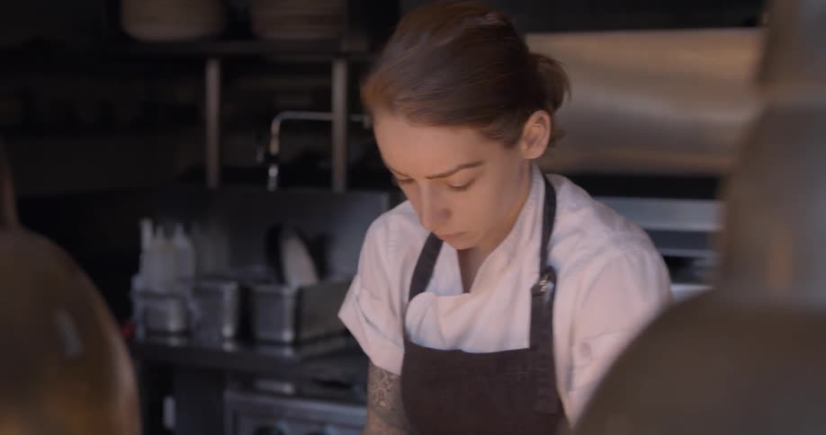 A chef makes pizza dough in a kitchen