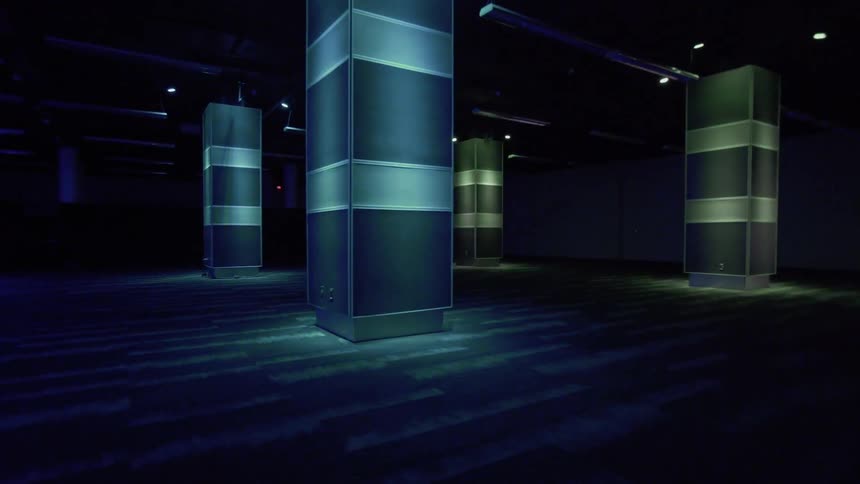 Lighted columns inside a building are changing colors