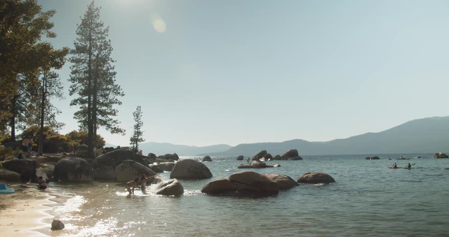 People splash in a mountain lake