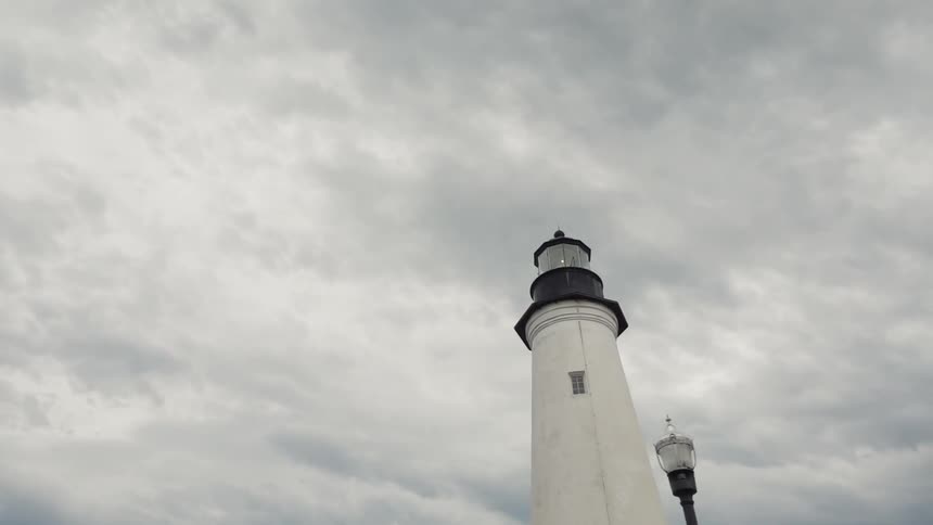 Clouds float above a lighthouse