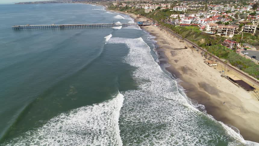 The waves hit the shore by the pier