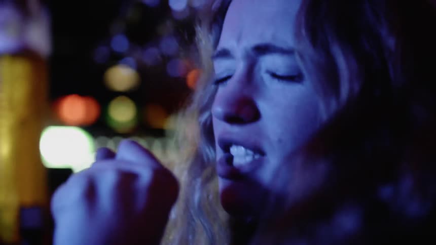 A woman mimics singing