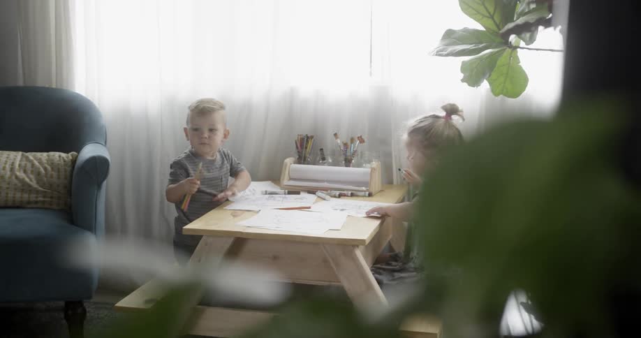 Two children play at a small table