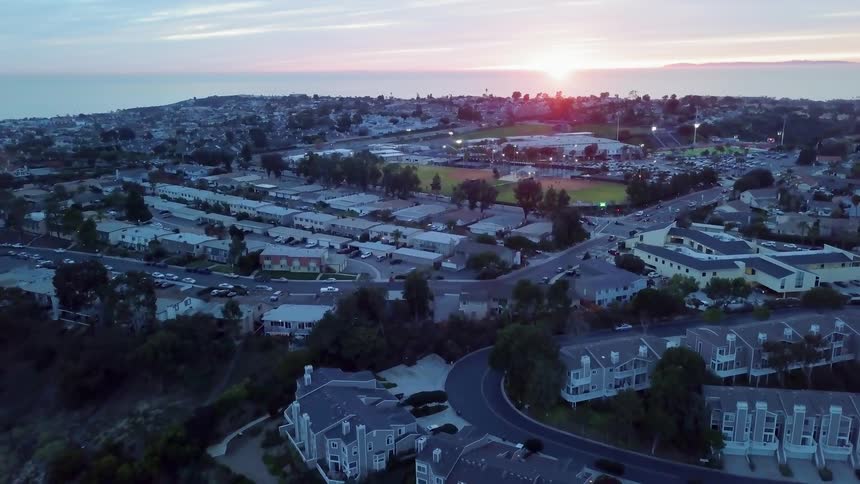 The sun sets over a city