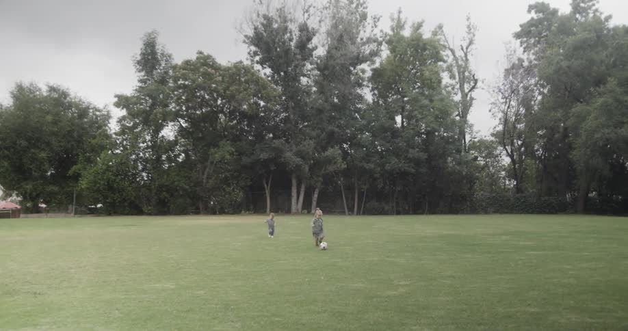 Children play with a soccer ball