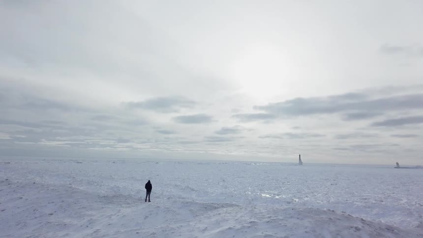 A person stands alone in a snowy expanse