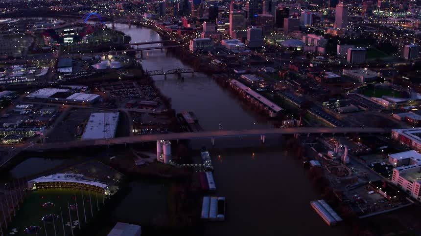A river flows through a city at sunset
