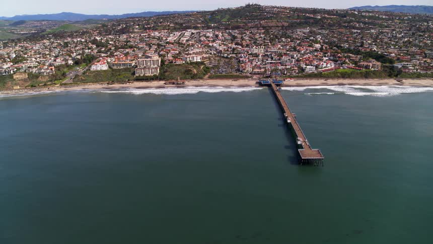 A pier extends into an ocean