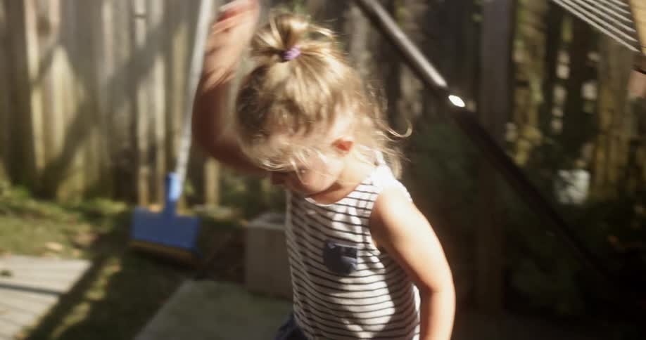 A young girl throws a rock
