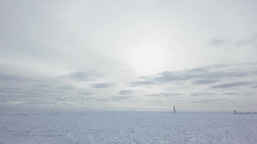 Person standing in vast desolate region covered in snow