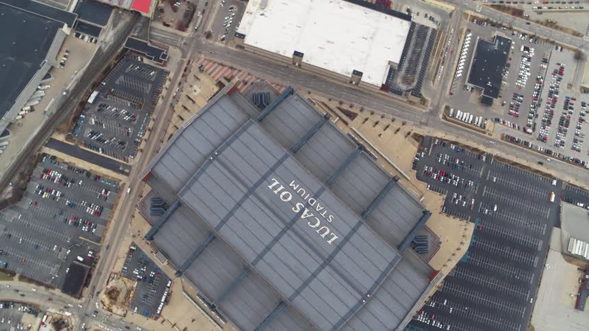 A large stadium surrounded by parking lots