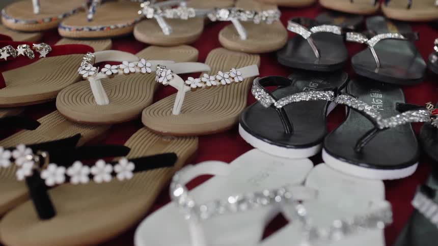 Rows of flip flops on a table
