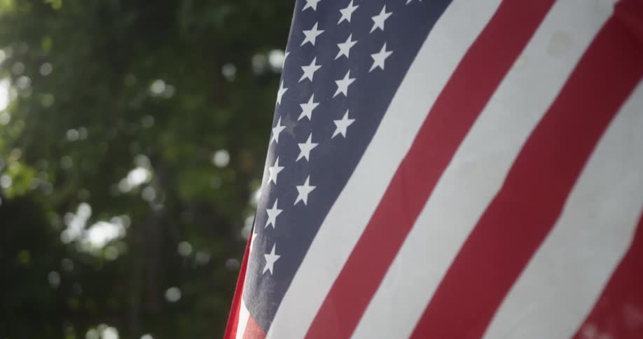 The flag blows in the wind on a sunny day