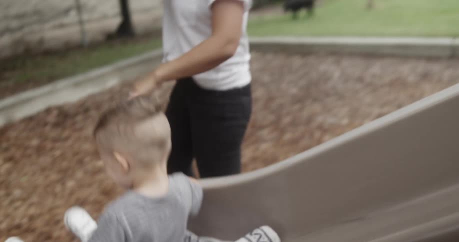 Kids playing on a slide at the park
