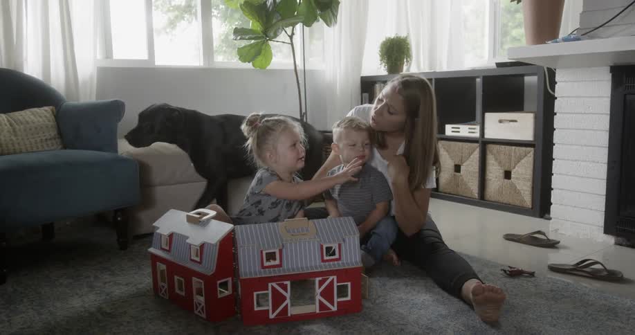 Mother plays with two children at home