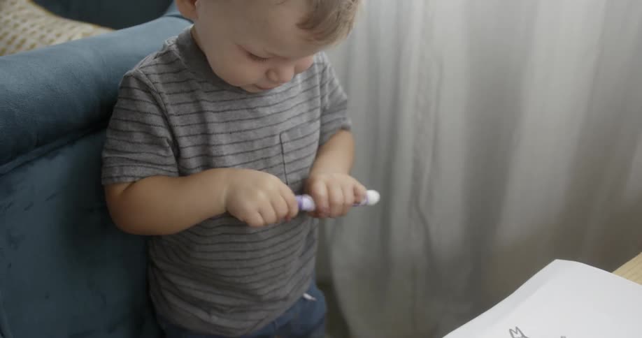 A young child coloring with markers