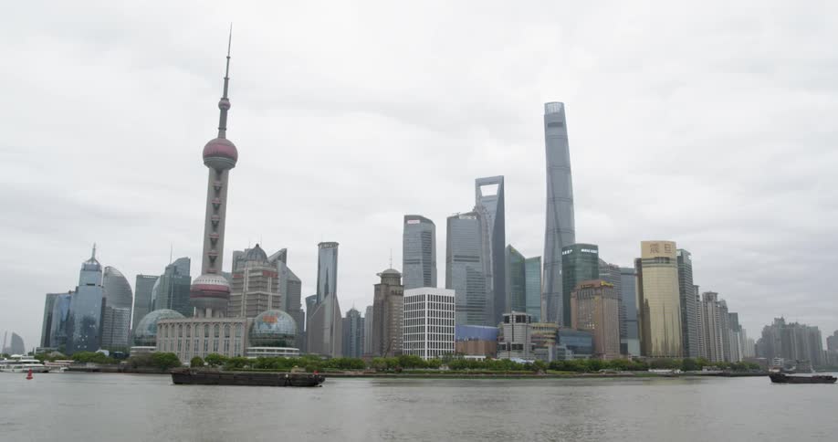 Boats float by city skyscrapers