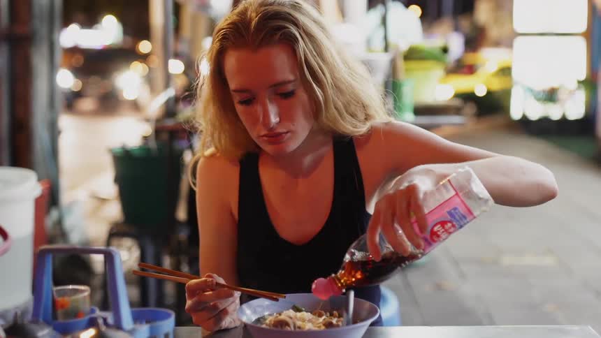 A woman eats alone at a table