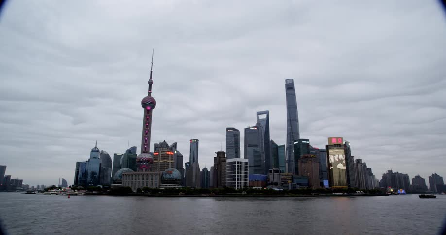 Boats float by city skyscrapers