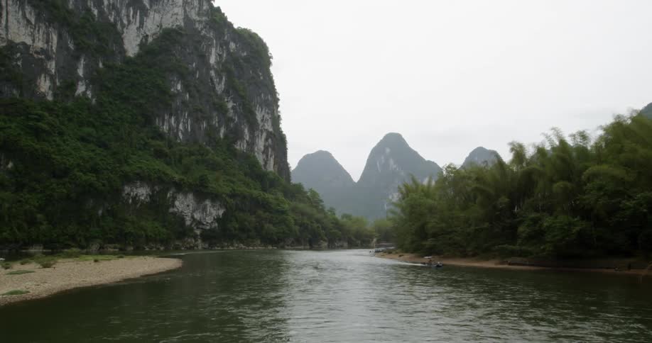 A boat floats on a mountain river