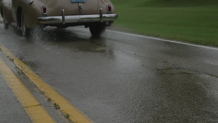 A car driving in the rain