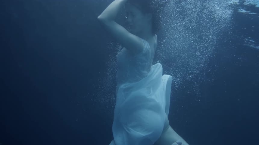 A woman sinks into the water