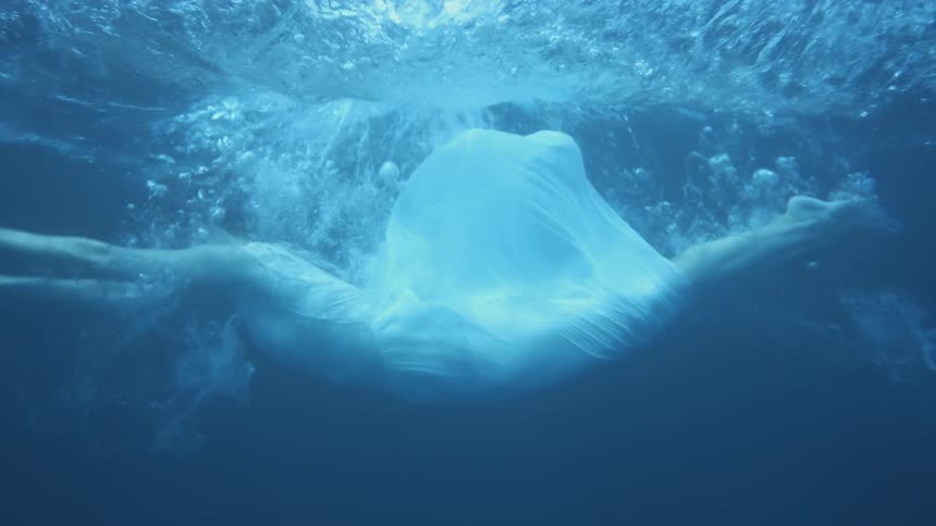 A clothed woman drowns in a lake