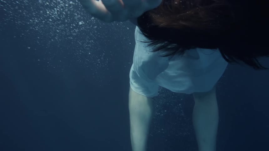 A woman sinks into the water