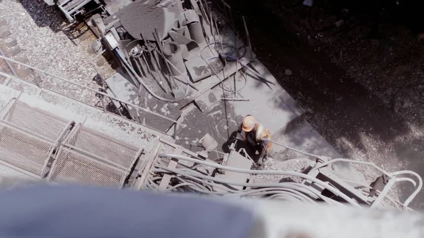 A construction worker works with heavy machinery