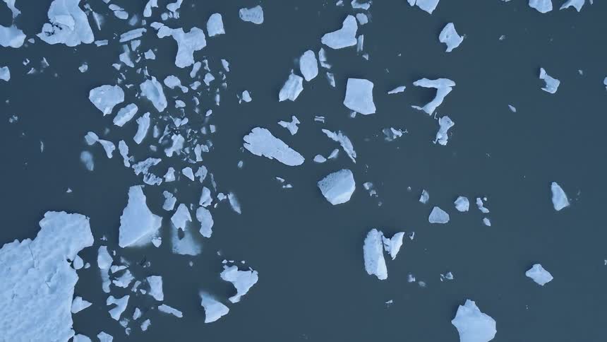 Ice and snow float on a lake in the wilderness