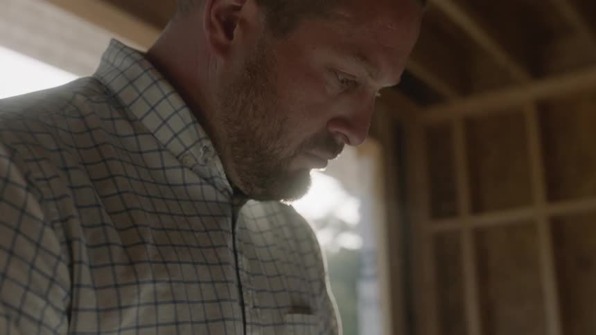 A man looks down in the garage