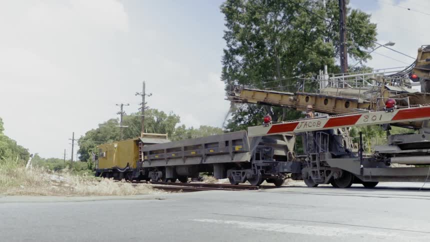 A train pulls slowly along the tracks