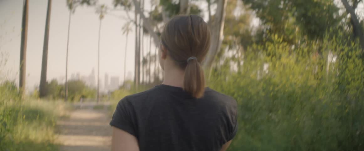 A woman walks down the trail