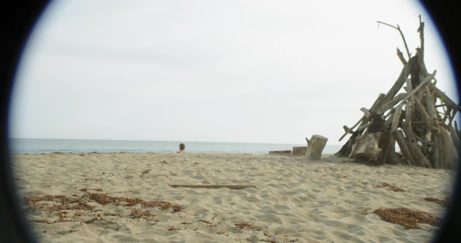 A man walks towards the water on the beach