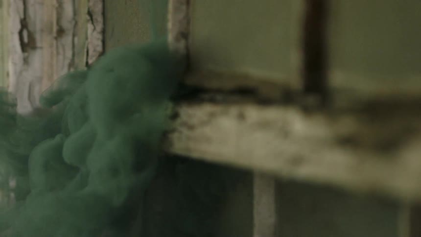 Green smoke pours from the window