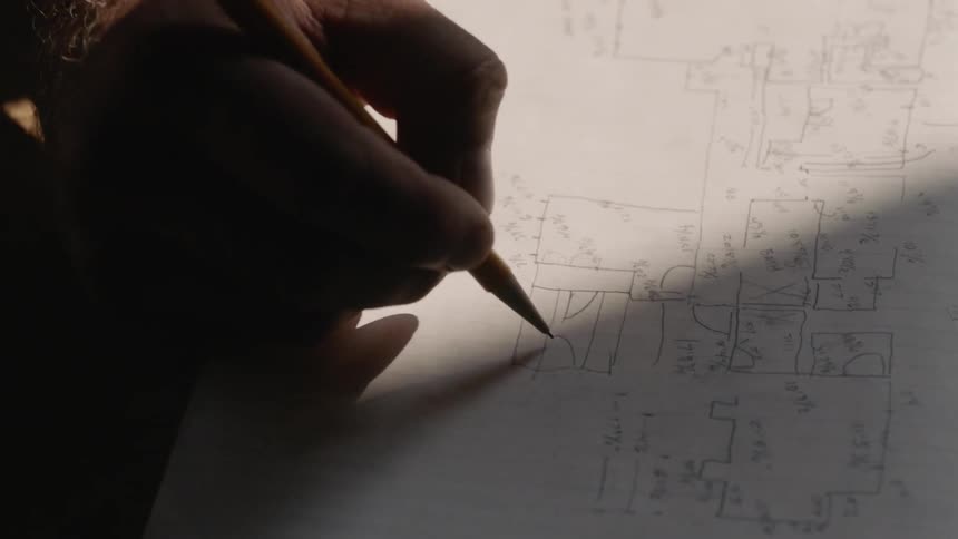 Person writing equations with a pencil