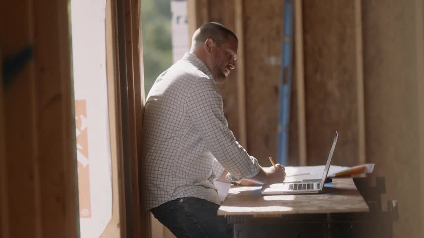 A man is working on his laptop