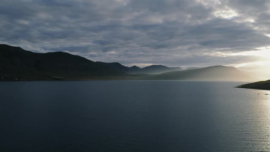 Fog is lingering on a coastline on a cloudy morning