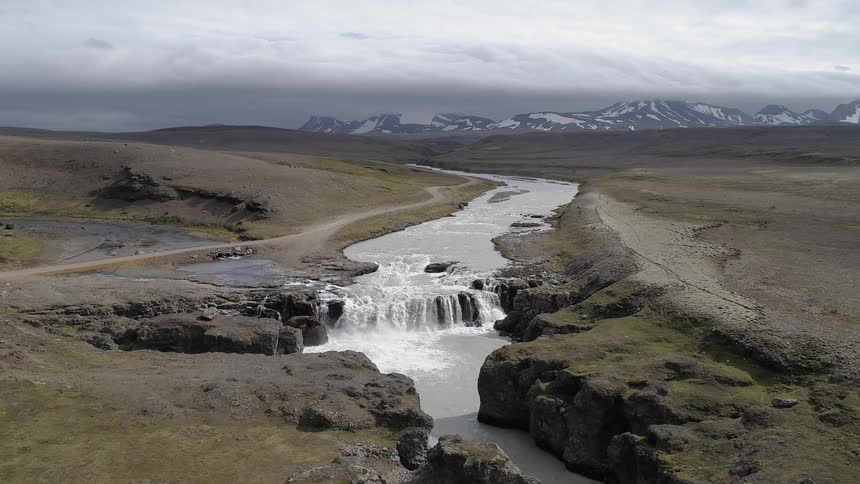A river flows over a cliff in the wilderness