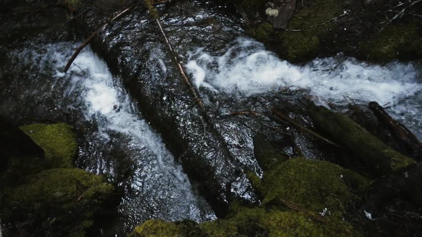 Water flows down the river and falls over the rocks
