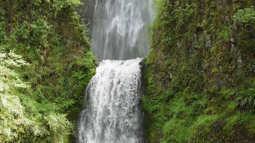 A waterfall flows over a cliff