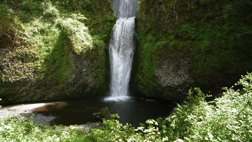 A waterfall flows over a cliff