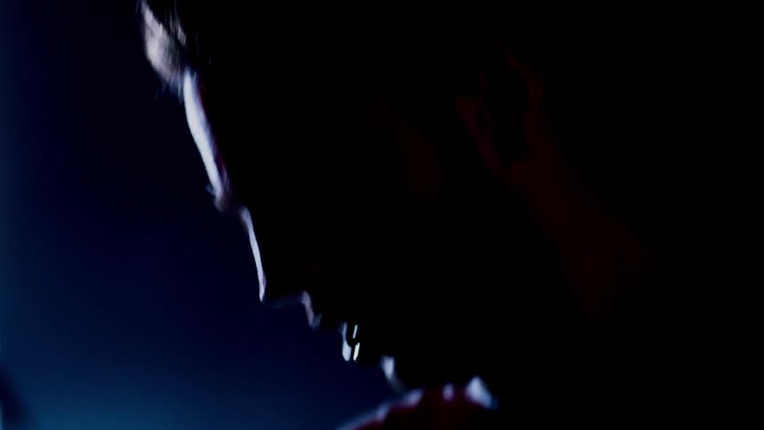 Man moves in a room with a bright light