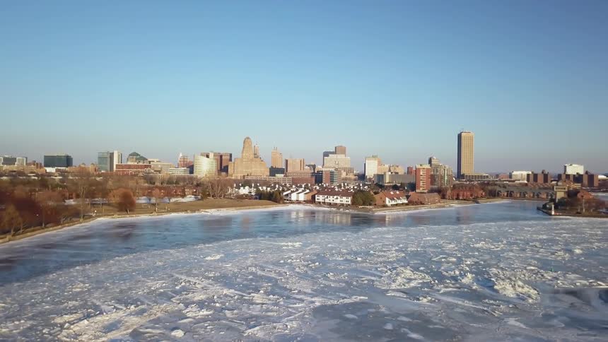 The shore is covered with ice by the city