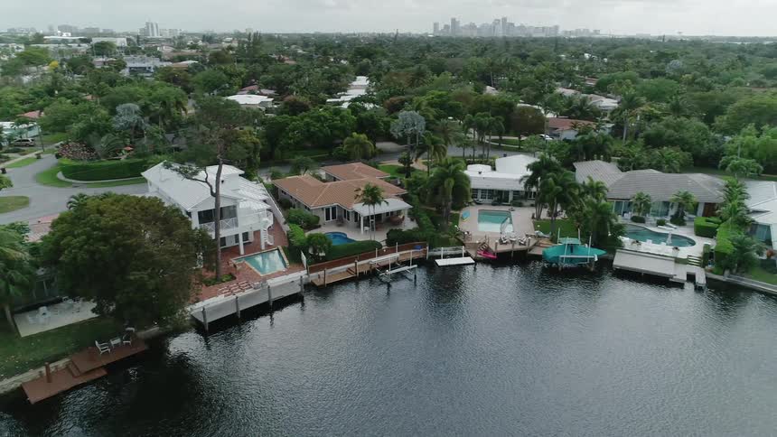 Water flows next to several houses