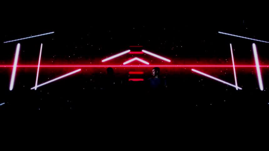 Two djs perform in front of a projection screen