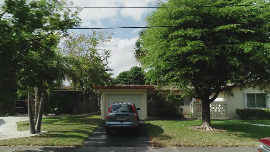 Cars are parked in the driveways of neighborhood homes
