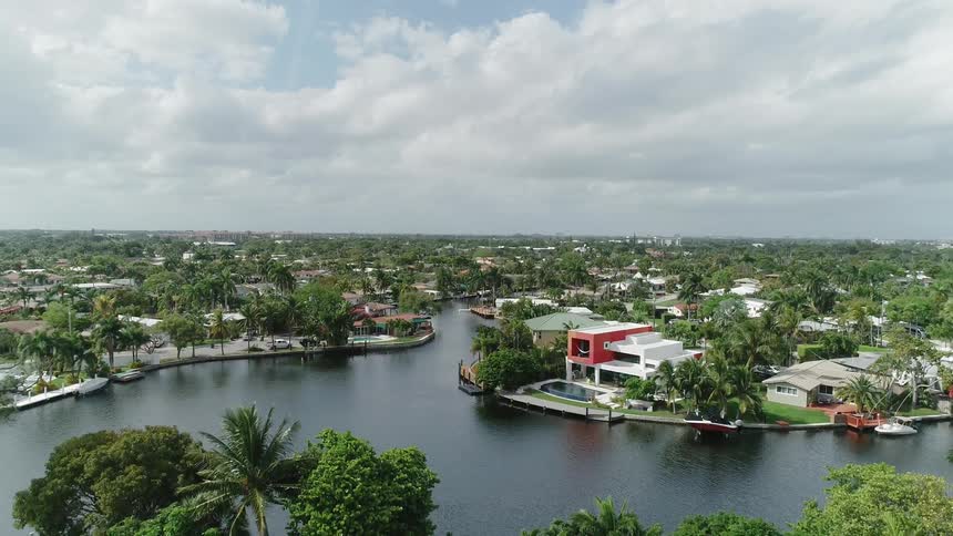 The water is calm by these homes